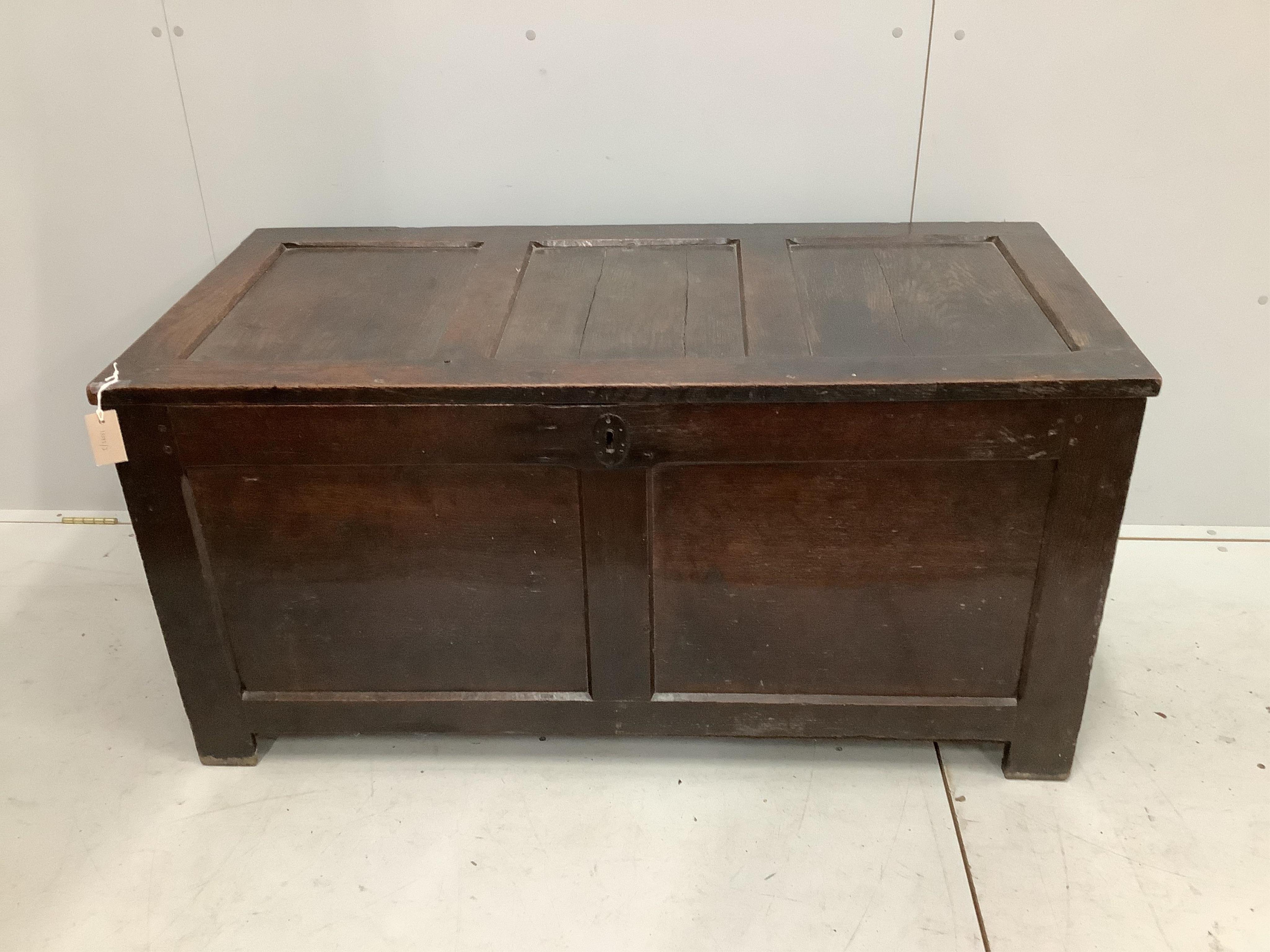 An early 18th century panelled oak coffer, width 126cm, height 62cm. Condition - fair to good, some splitting to the top panels